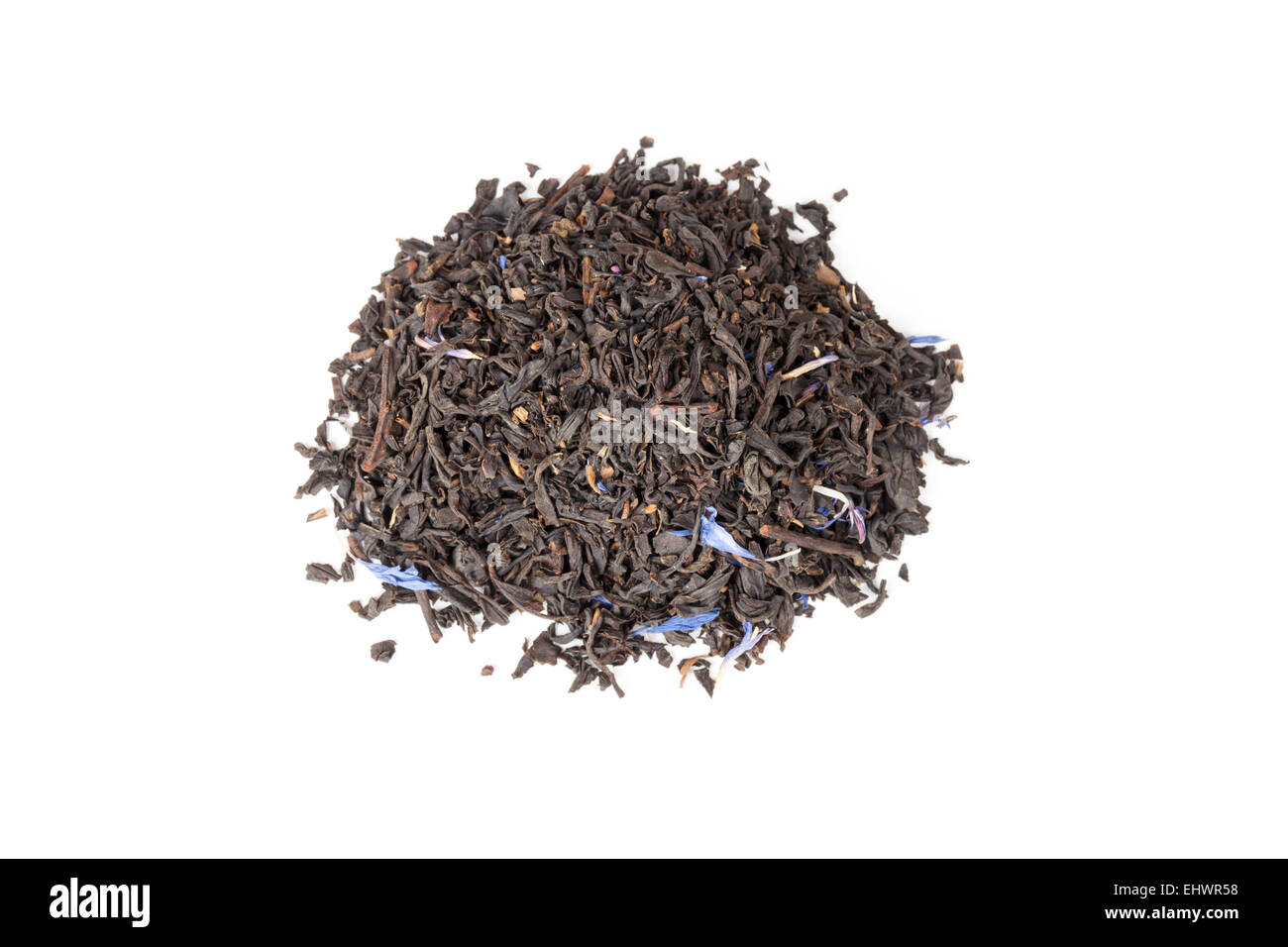 Small pile of big leaf black tea mixed with blue cornflower petals and pieces of bergamot isolated on white background, top view Stock Photo