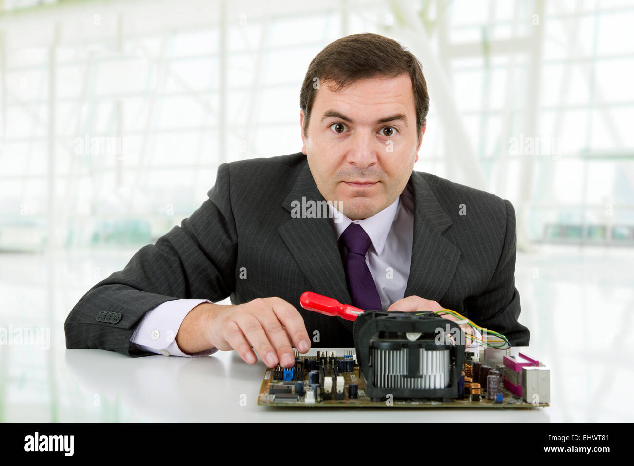 Computer Engineer working in a motherboard, at the office Stock Photo