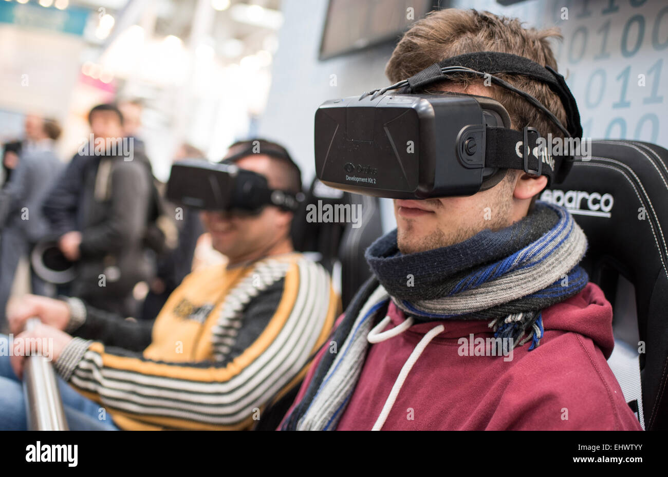Visitors try the new Oculus Rift virutal reality data glasses during the computer and electronics fair 'CeBIT 2015' in Hanover, Germany, 17 March 2015. The CeBIT 2015 continues until 20 March 2015. Photo: Ole Spata/dpa Stock Photo