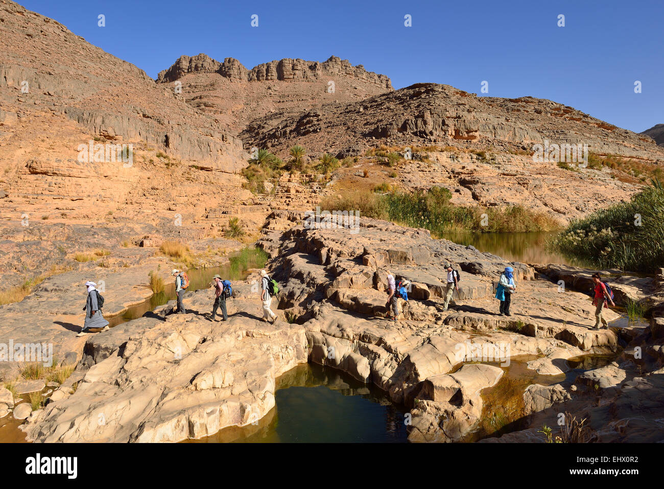 Algeria, Tassili N'Ajjer National Park, Group of people hiking in Idaran Canyon Stock Photo