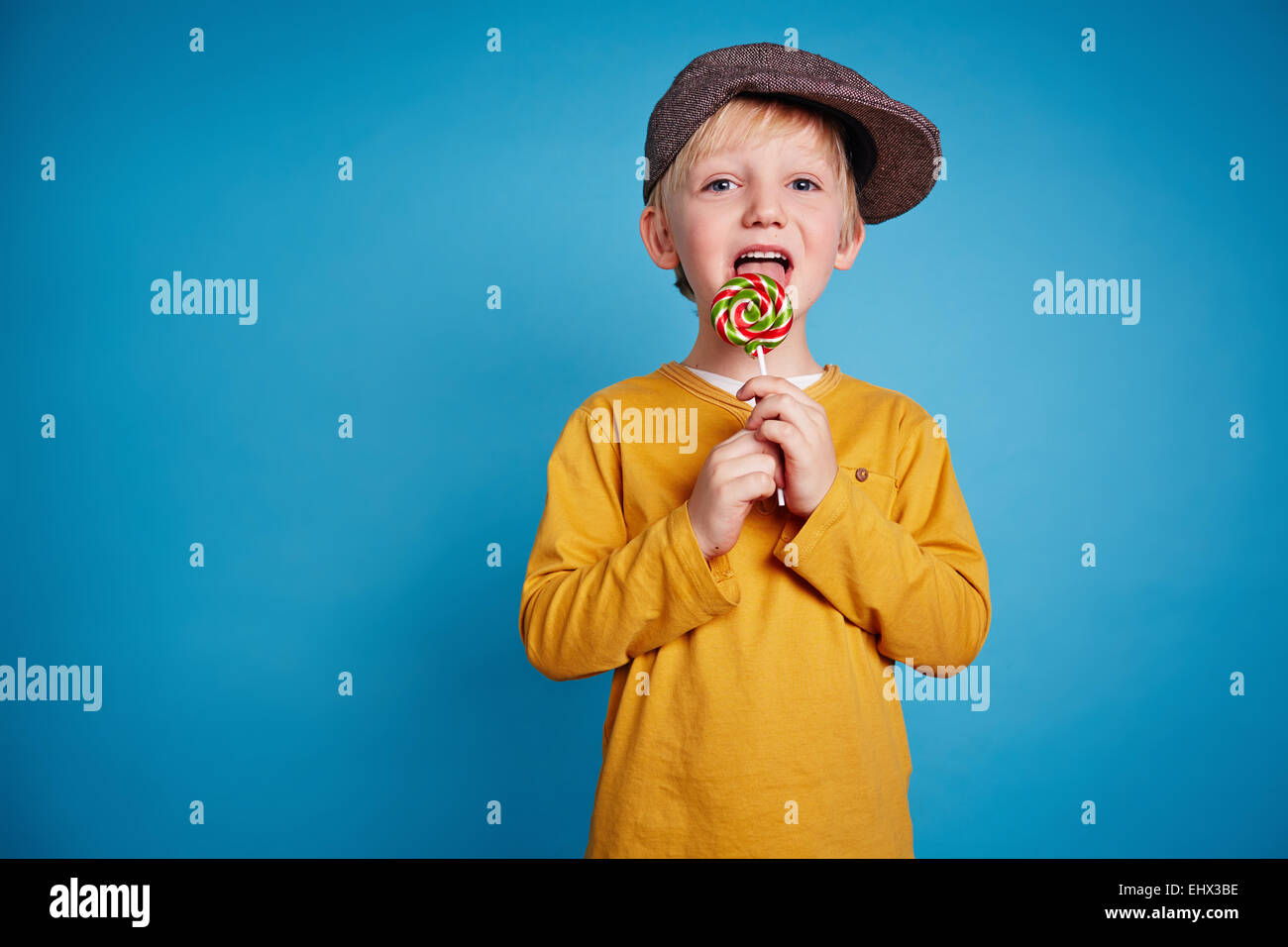 Boy licking lollipop Stock Photo