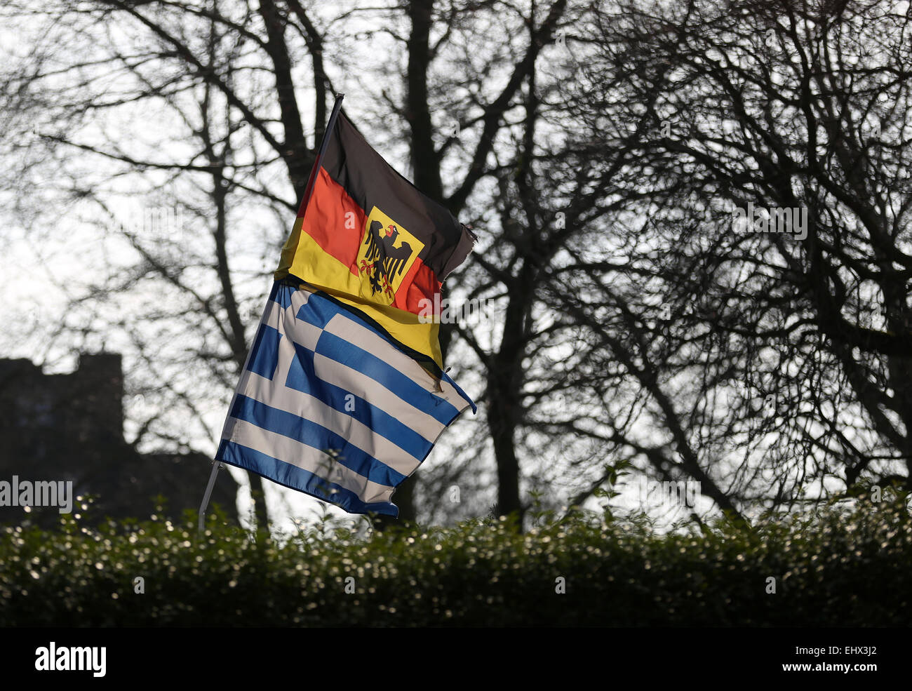 The German Top And The Greek National Flags Sway In The Wind In