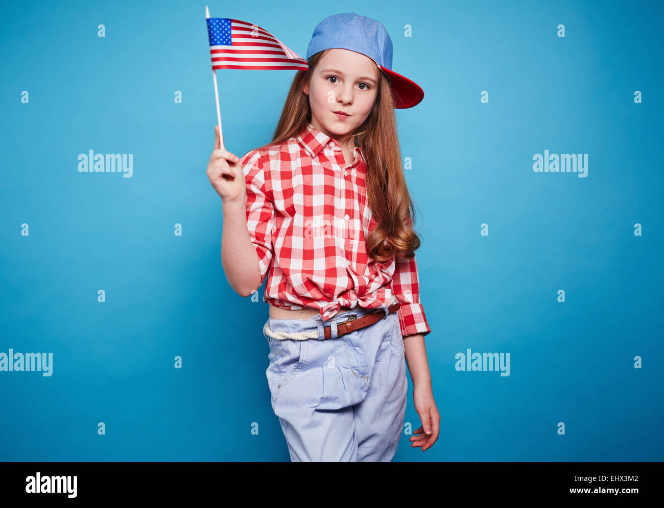Beautiful girl holding American flag on a stick Stock Photo Alamy
