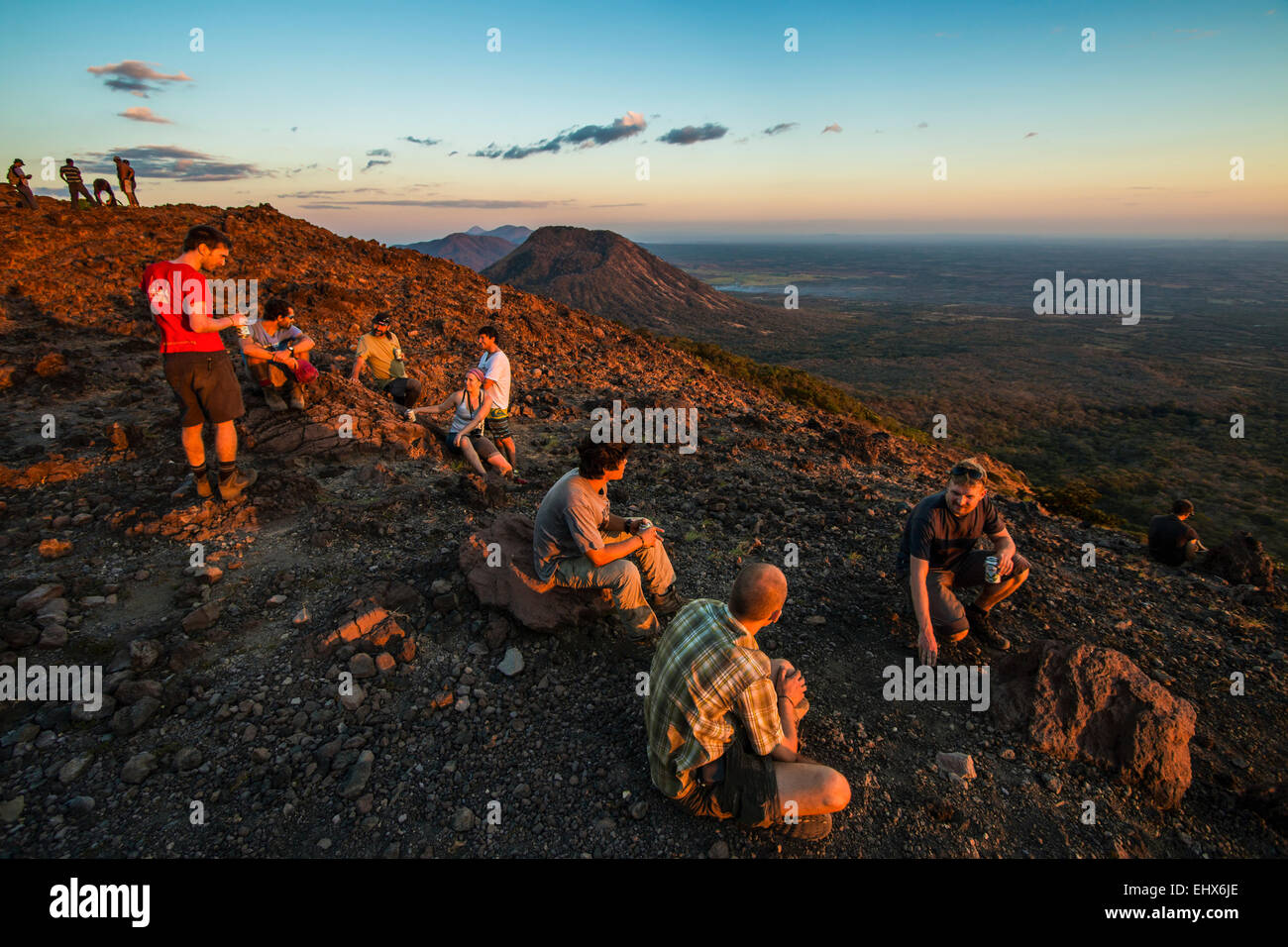 Hikers enjoy the sunset at the summit of active Volcano Telica, a popular tour from the NW city of Leon; Leon, Nicaragua Stock Photo