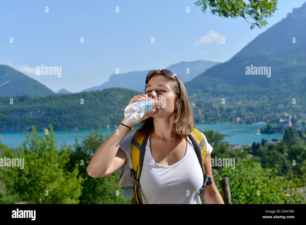pretty young woman is resting during a hike in the French Alps Stock ...