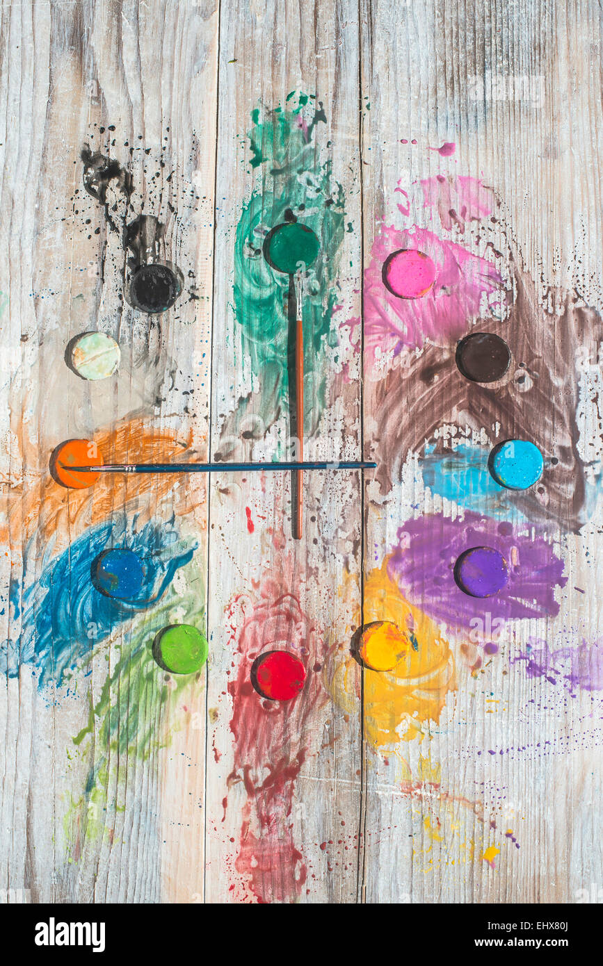 Watercolor paints and brushes forming a clock Stock Photo