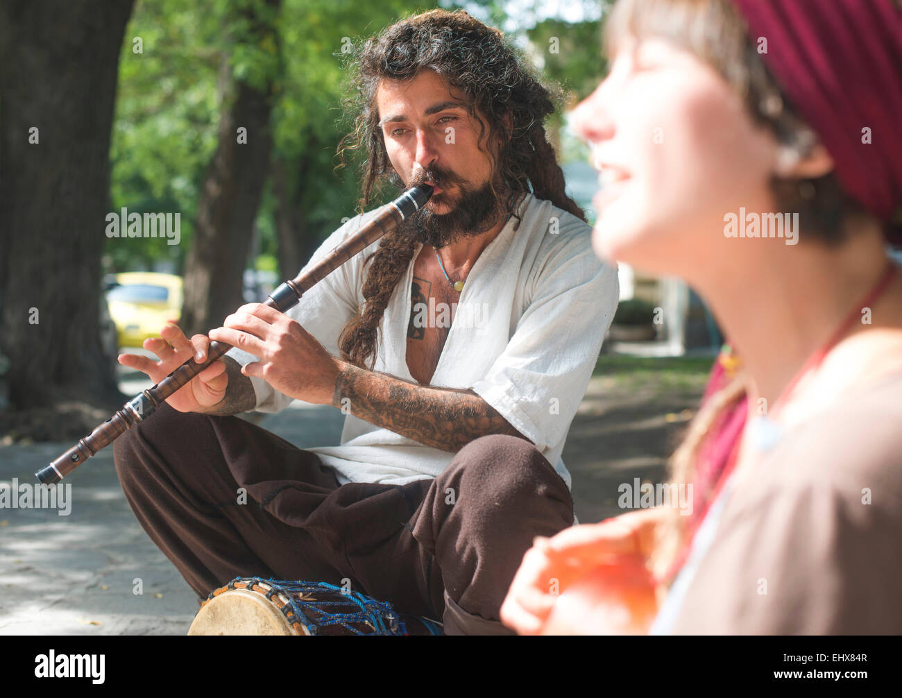 Street musician playing flute Stock Photo