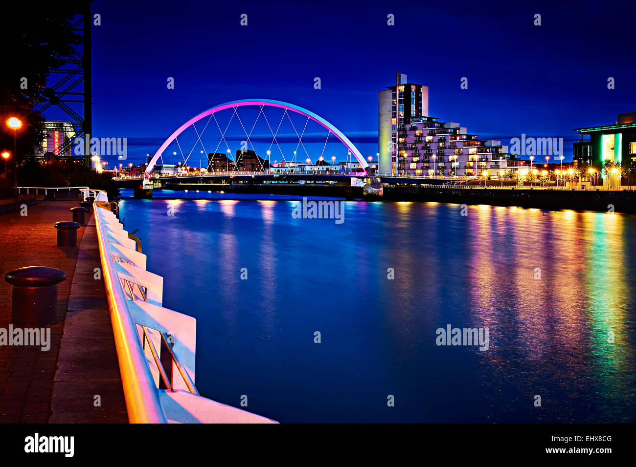 A night shot along the river Clyde, looking upriver to the Clyde Arc bridge from the SECC. Stock Photo