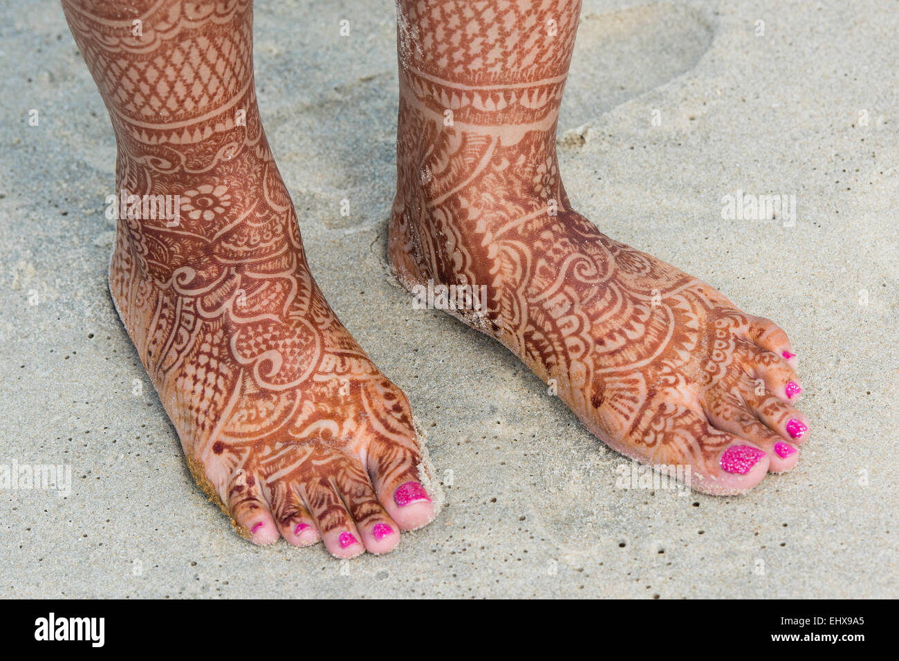 Feet of a bridge painted with henna, traditional mehndi design, beach