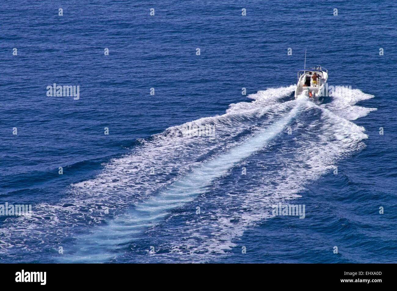 Motorboat speeding ahead at full power  leaving straight wake behind Stock Photo