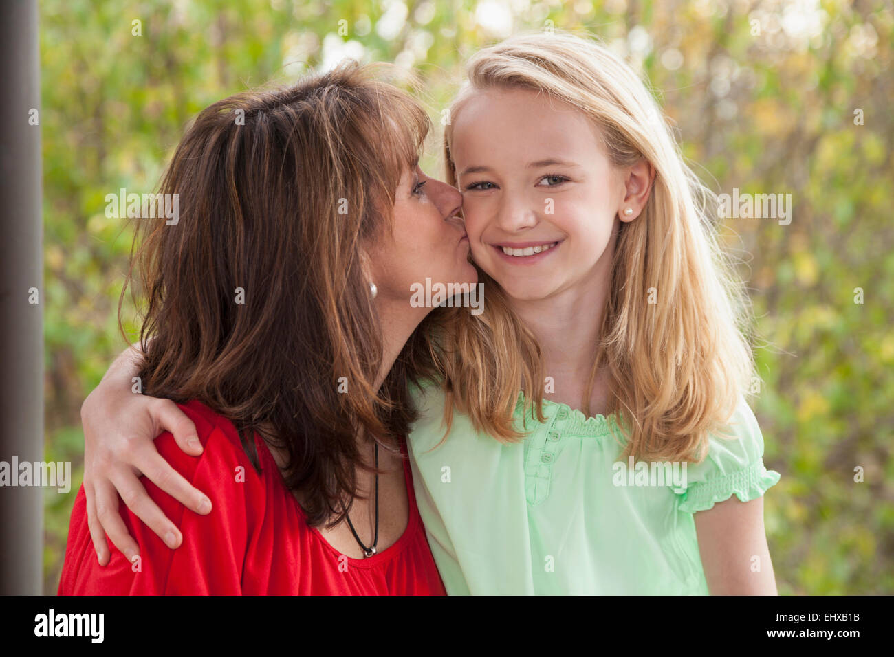Woman kissing her daughter, Bavaria, Germany Stock Photo