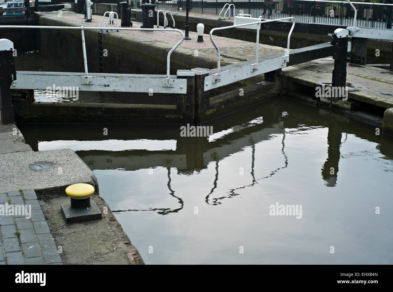 Camden town canal Lock gate with yellow cast iron mooring bollards painted yellow Stock Photo