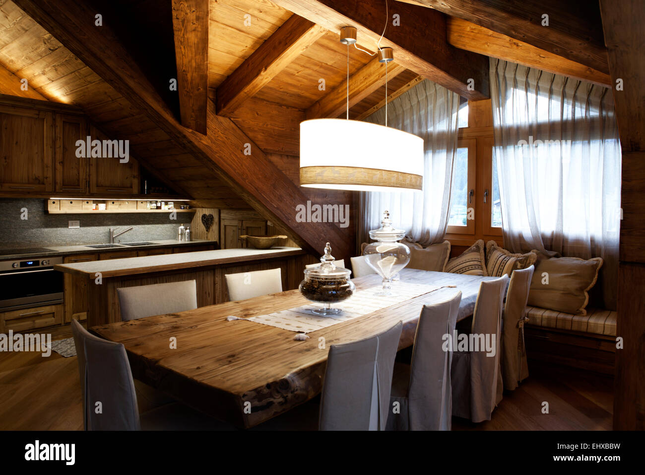 Alpine attic dining room table for eight seats Stock Photo