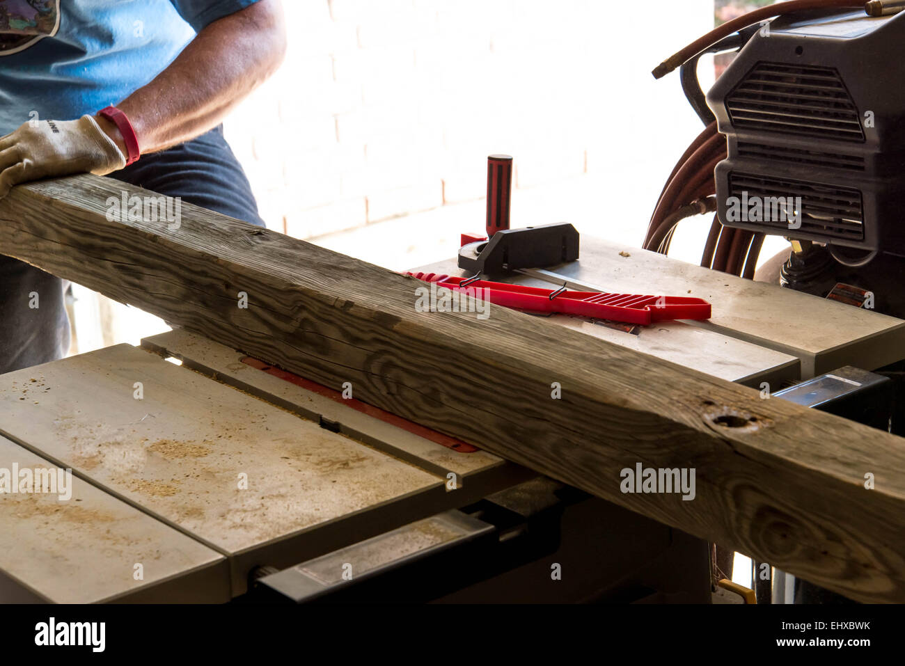 man cutting 4x4 on table saw in a garage Stock Photo Alamy