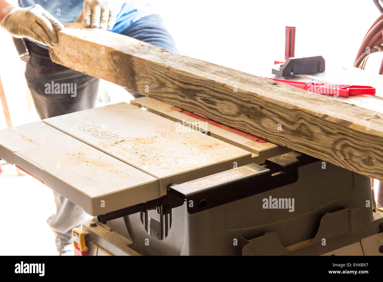 man cutting 4x4 on table saw in a garage Stock Photo Alamy