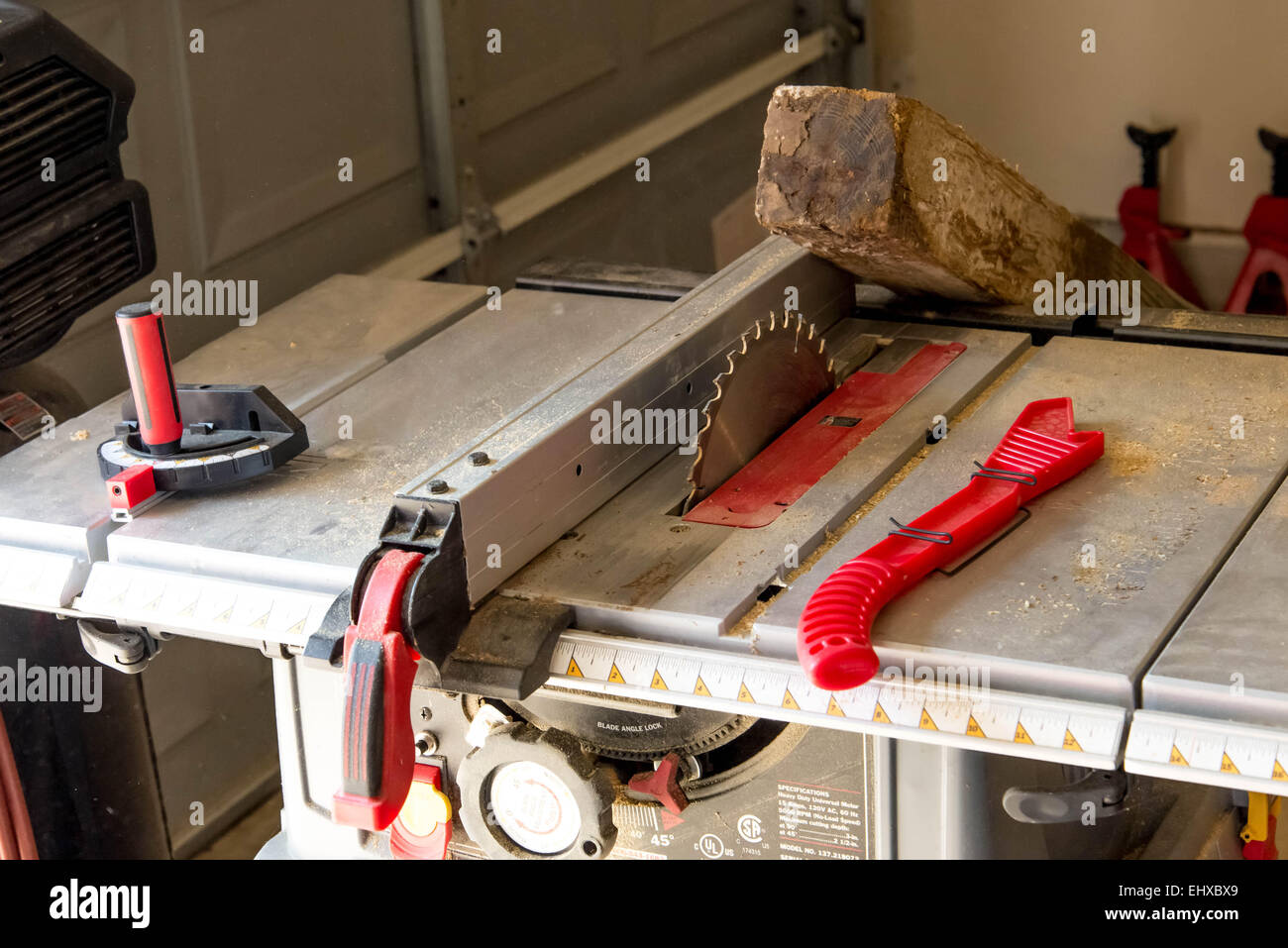 man cutting 4x4 on table saw in a garage Stock Photo Alamy