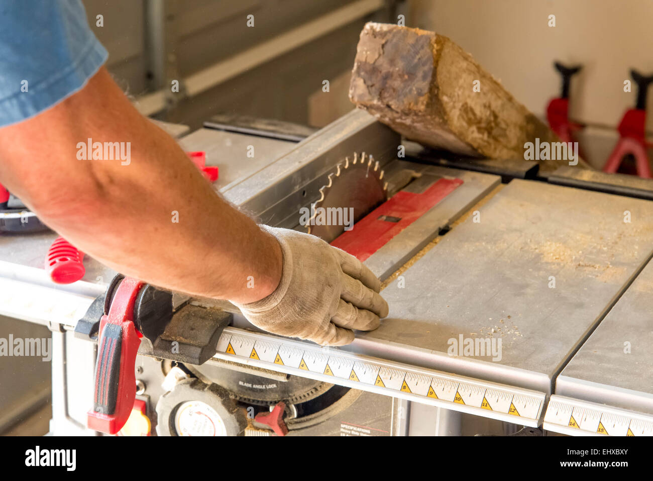 man cutting 4x4 on table saw in a garage Stock Photo Alamy