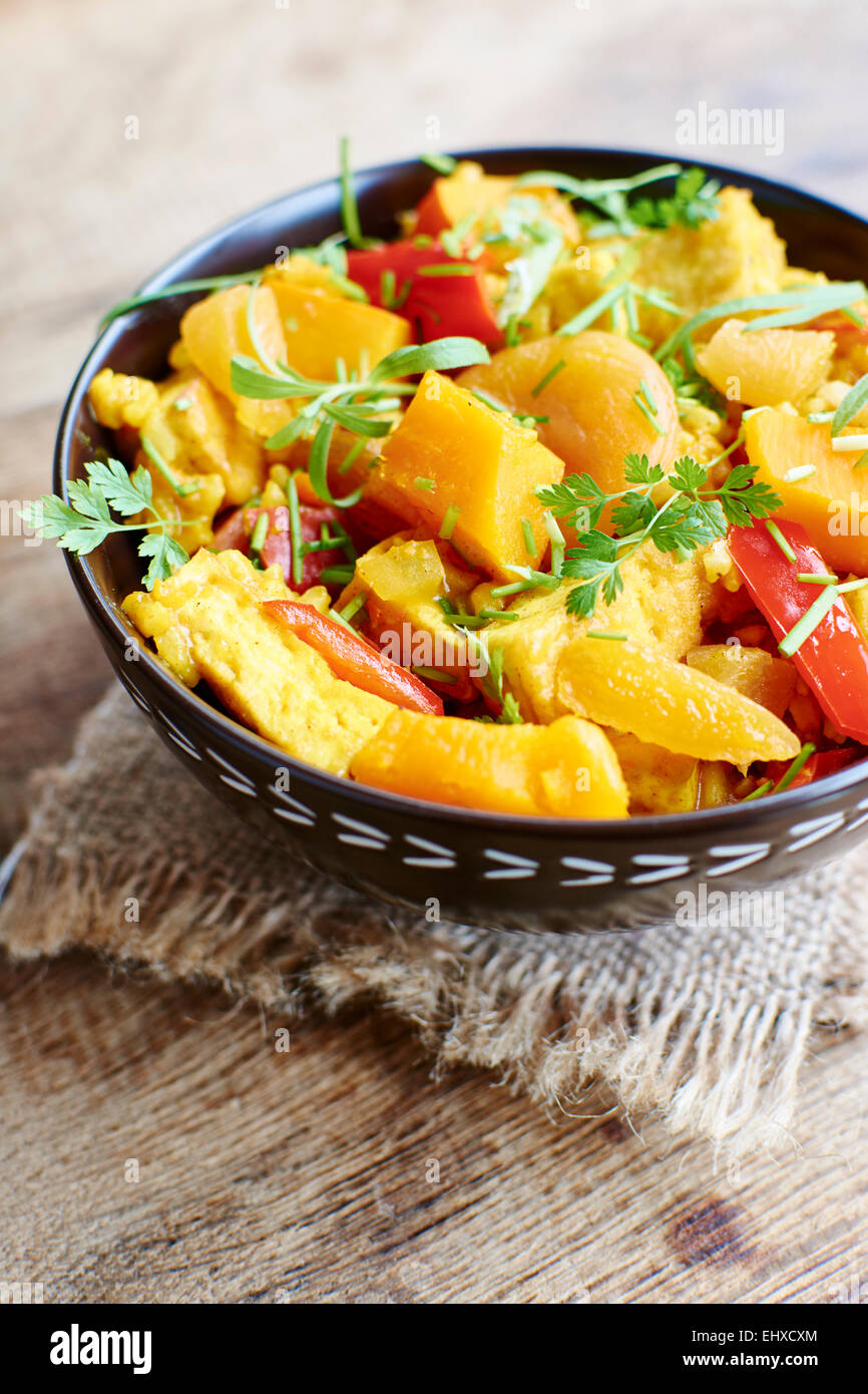 Pumpkin risotto with tofu, apricots, bell pepper and herbs Stock Photo