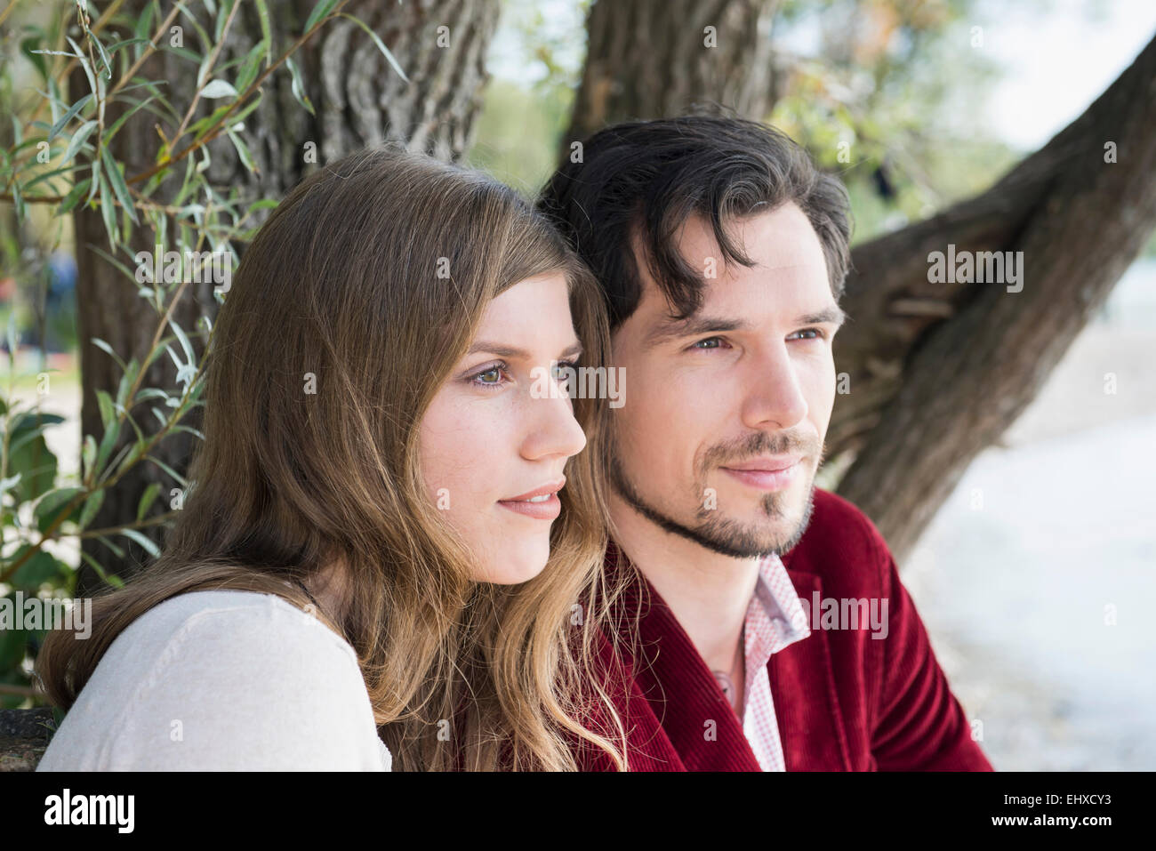Close up portrait young couple sitting lake Stock Photo