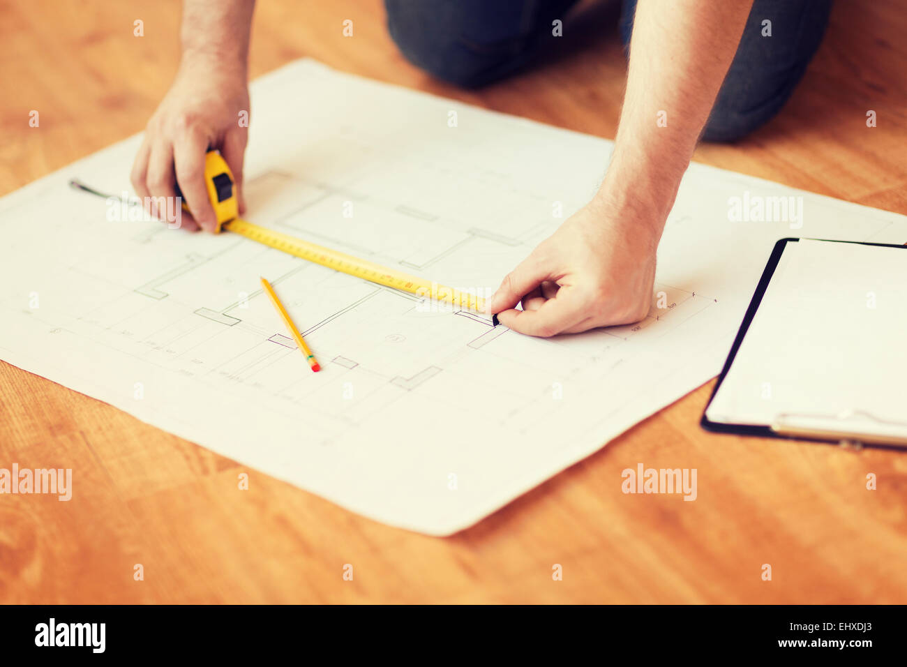 close up of male hands measuring blueprint Stock Photo Alamy
