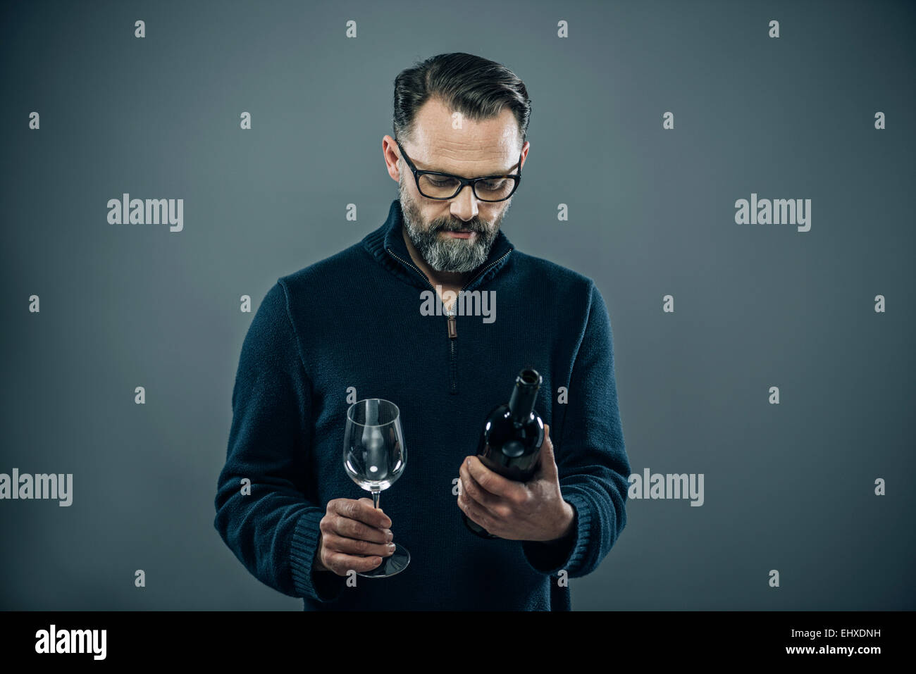 Man with red wine glass and wine bottle Stock Photo - Alamy