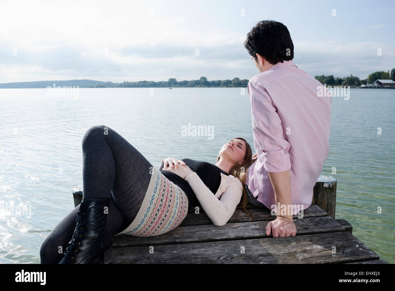 Young couple lake water jetty relaxing Stock Photo
