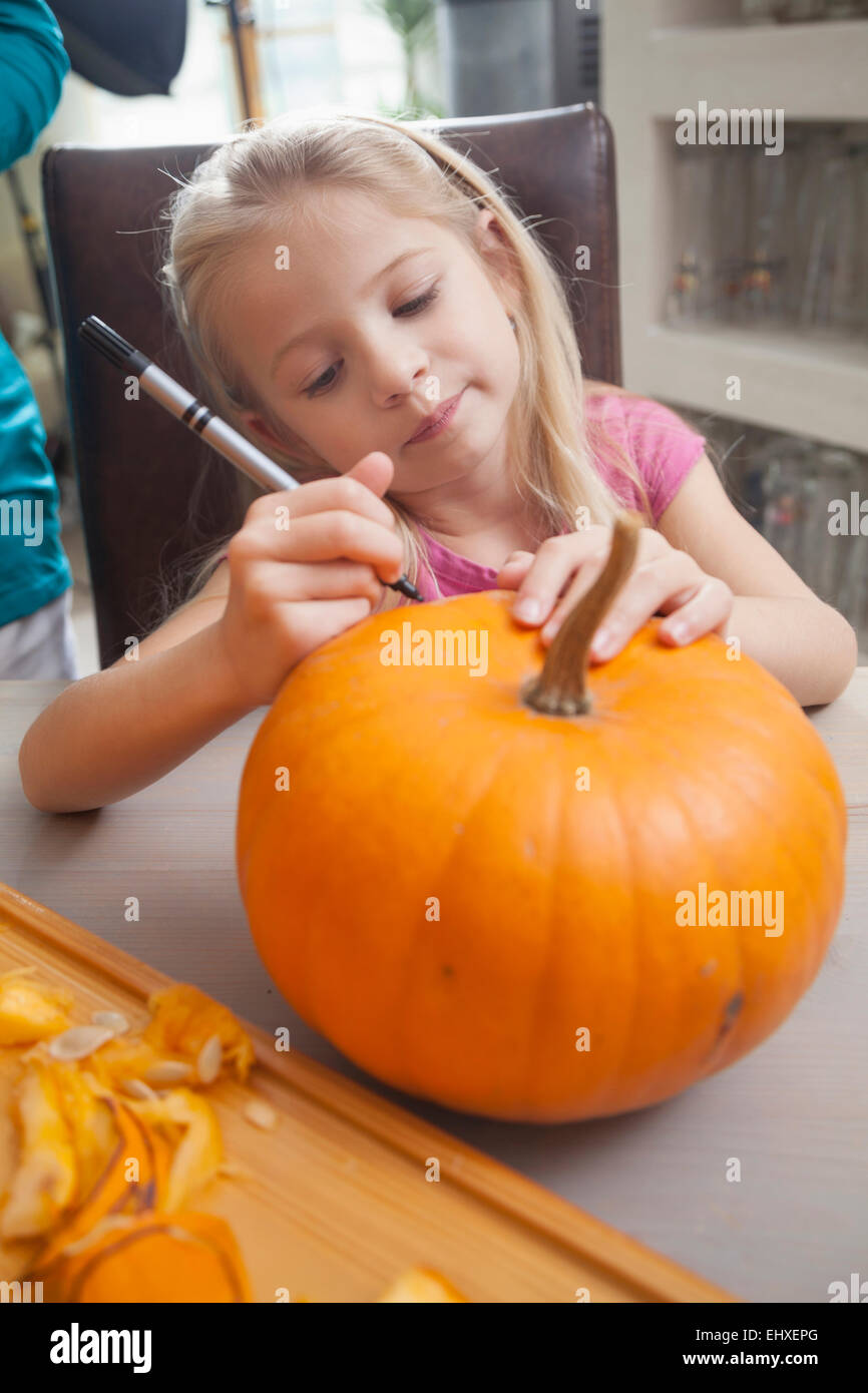 Girl carving pumpkin for Halloween, Bavaria, Germany Stock Photo