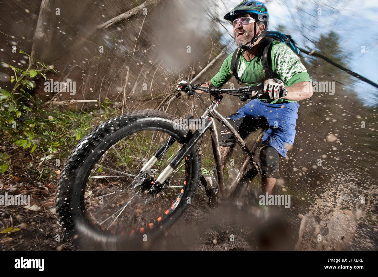 Mountain biker riding on a dirt road, Bavaria, Germany Stock Photo