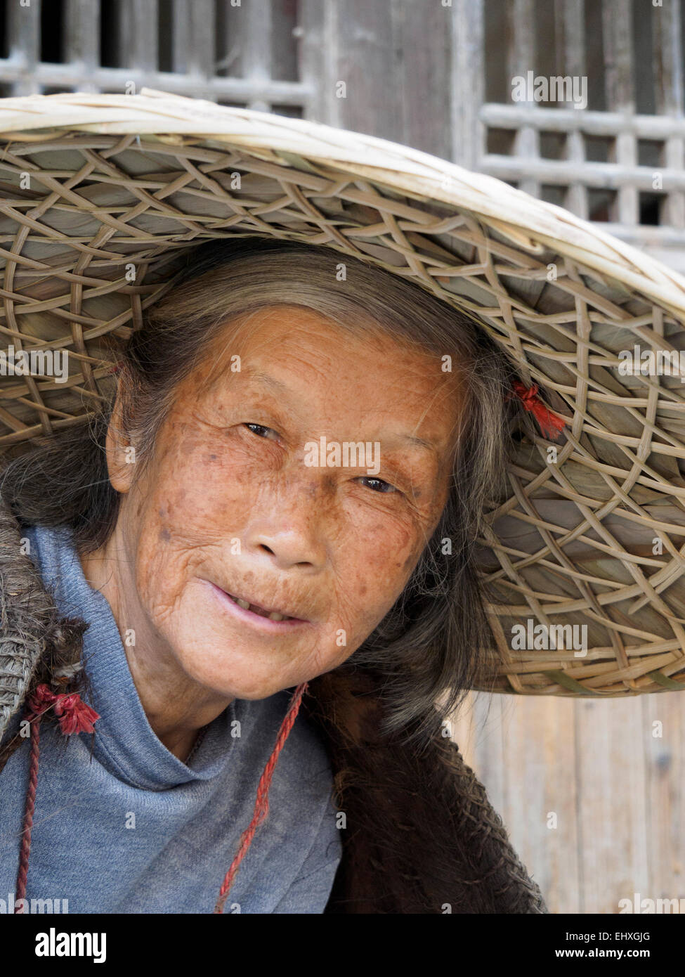 Asian old woman with traditional straw hat Stock Photo