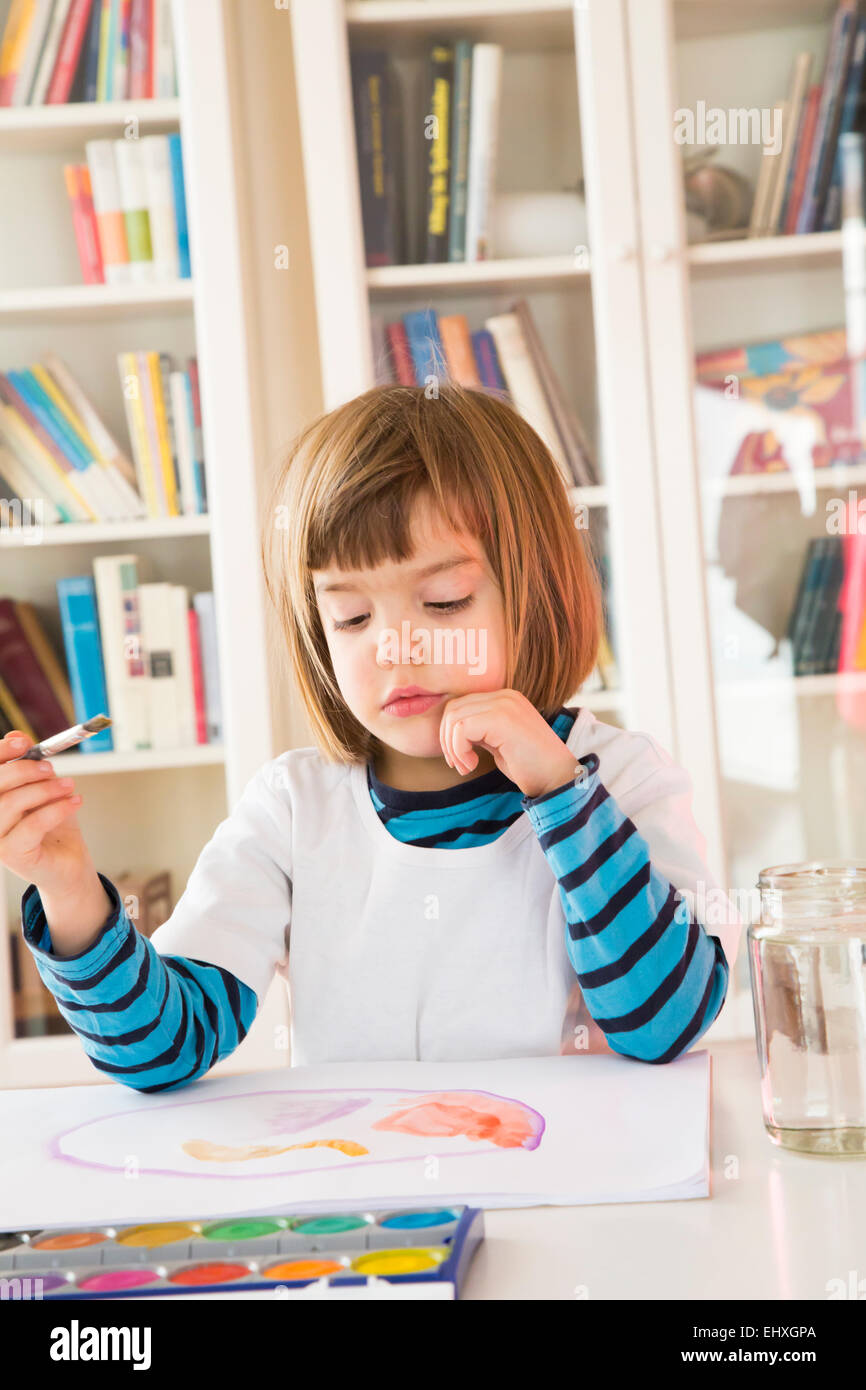 Portrait of little girl painting with watercolours Stock Photo - Alamy