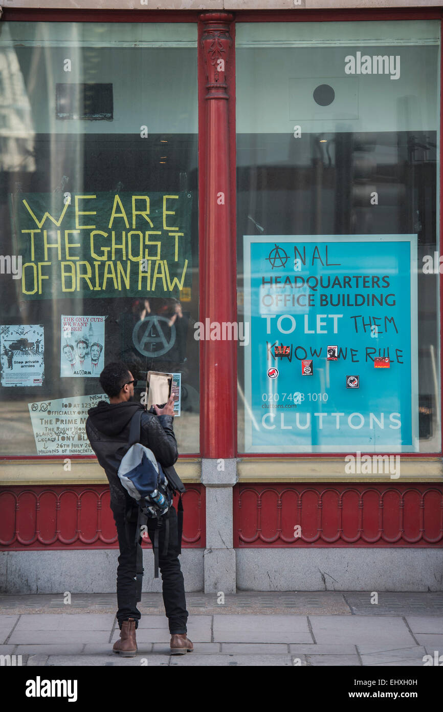 London, UK. 18th Mar, 2015. Squatters occupy an empty building next to the Institute of Directors in Pall Mall. They are anti capitalist and are raising concerns about the London housing crisis on Budget Day. The mix of occupants include anti-frackers and anarchists. Credit:  Guy Bell/Alamy Live News Stock Photo