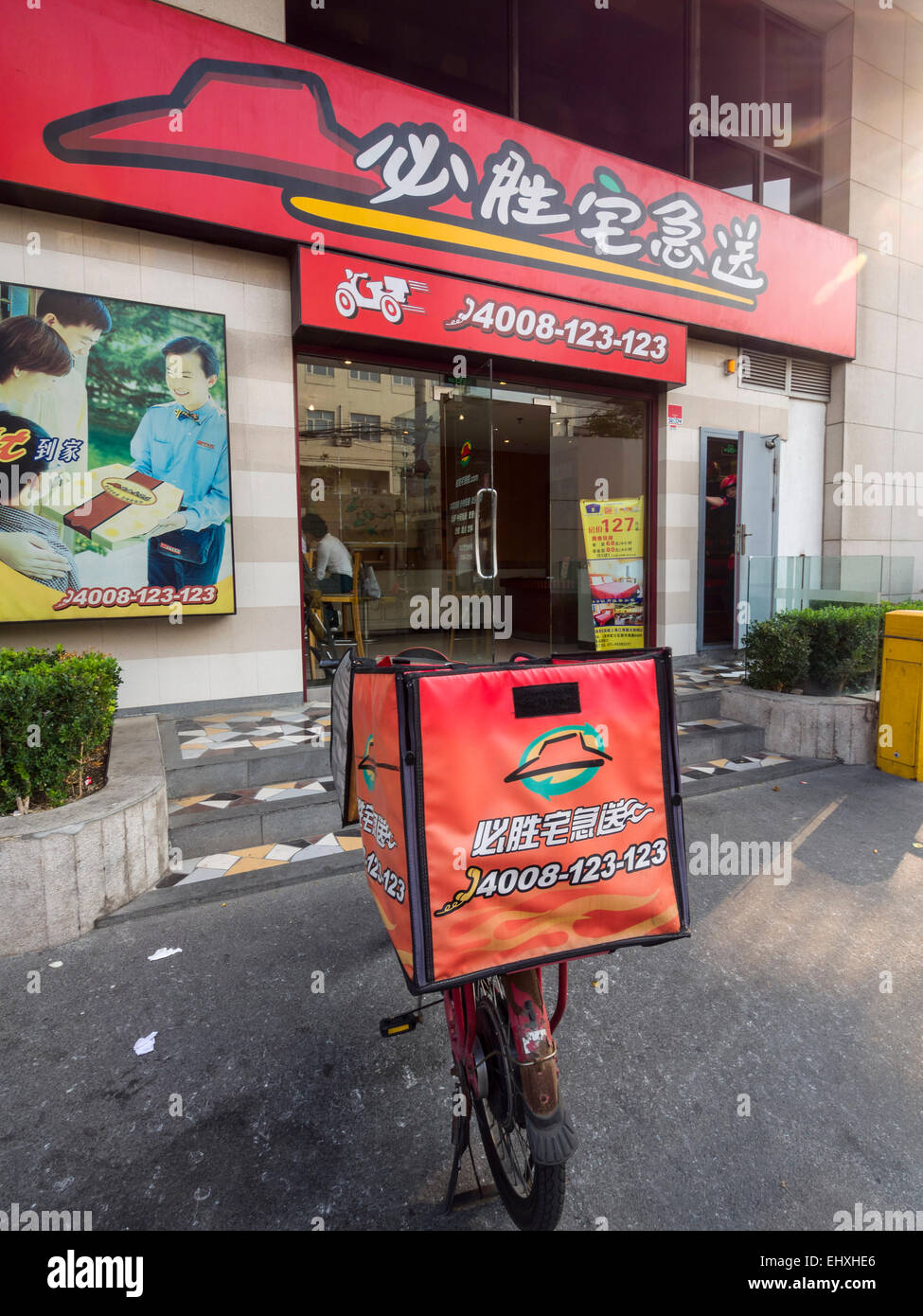 Delivery motorcycle outside a Pizza Hut restaurant in Shanghai, China Stock Photo