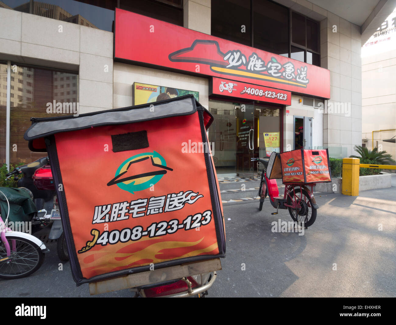 Delivery motorcycle outside a Pizza Hut restaurant in Shanghai, China Stock Photo