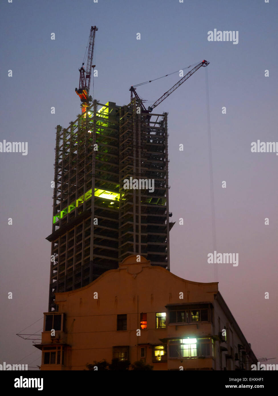 Skyscraper under construction at night in Shanghai, China Stock Photo ...