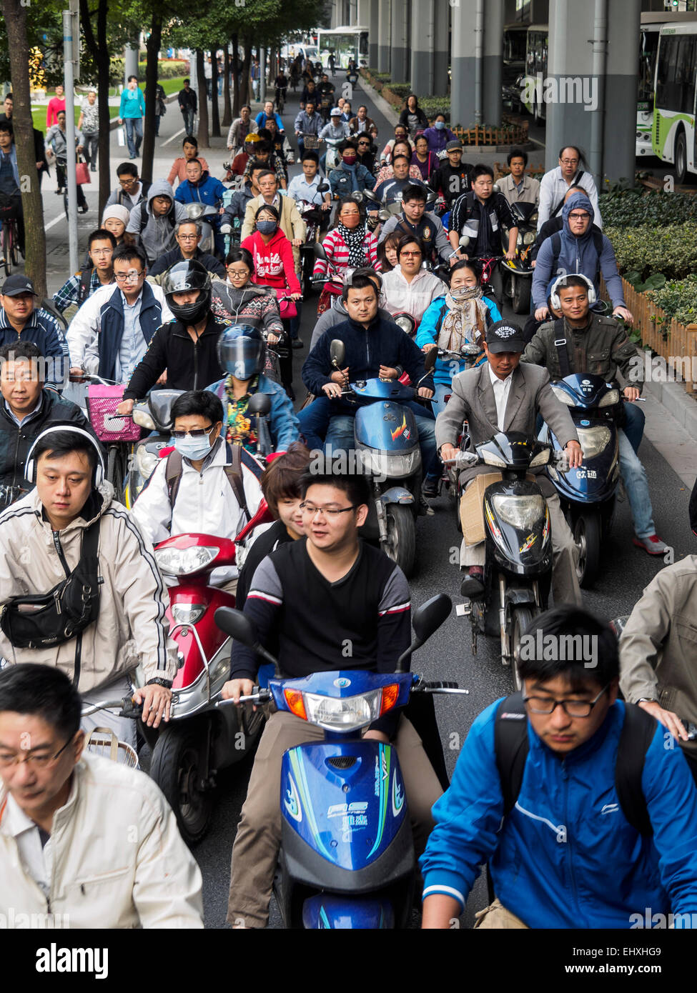 Chinese people on scooters waiting in traffic, Shanghai, China Stock Photo