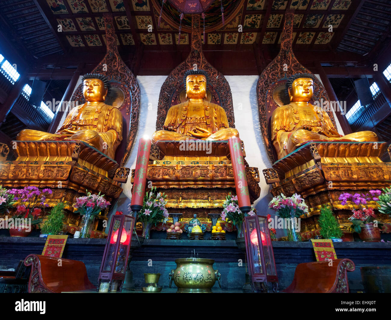 Three sitting Buddahs golden statues at the Jade Buddha temple in Shanghai, China Stock Photo