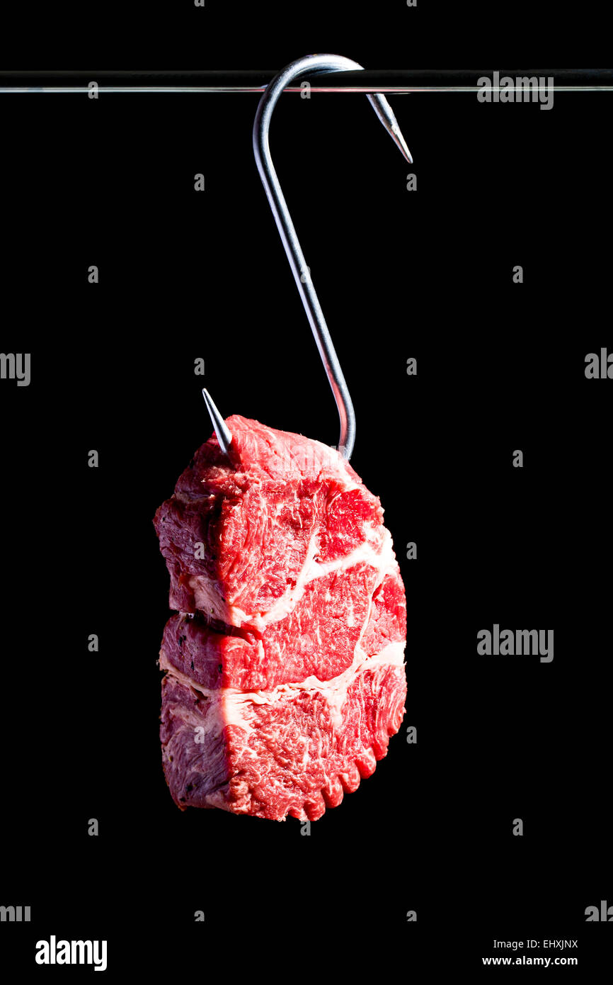 Raw beef on meat hook Stock Photo