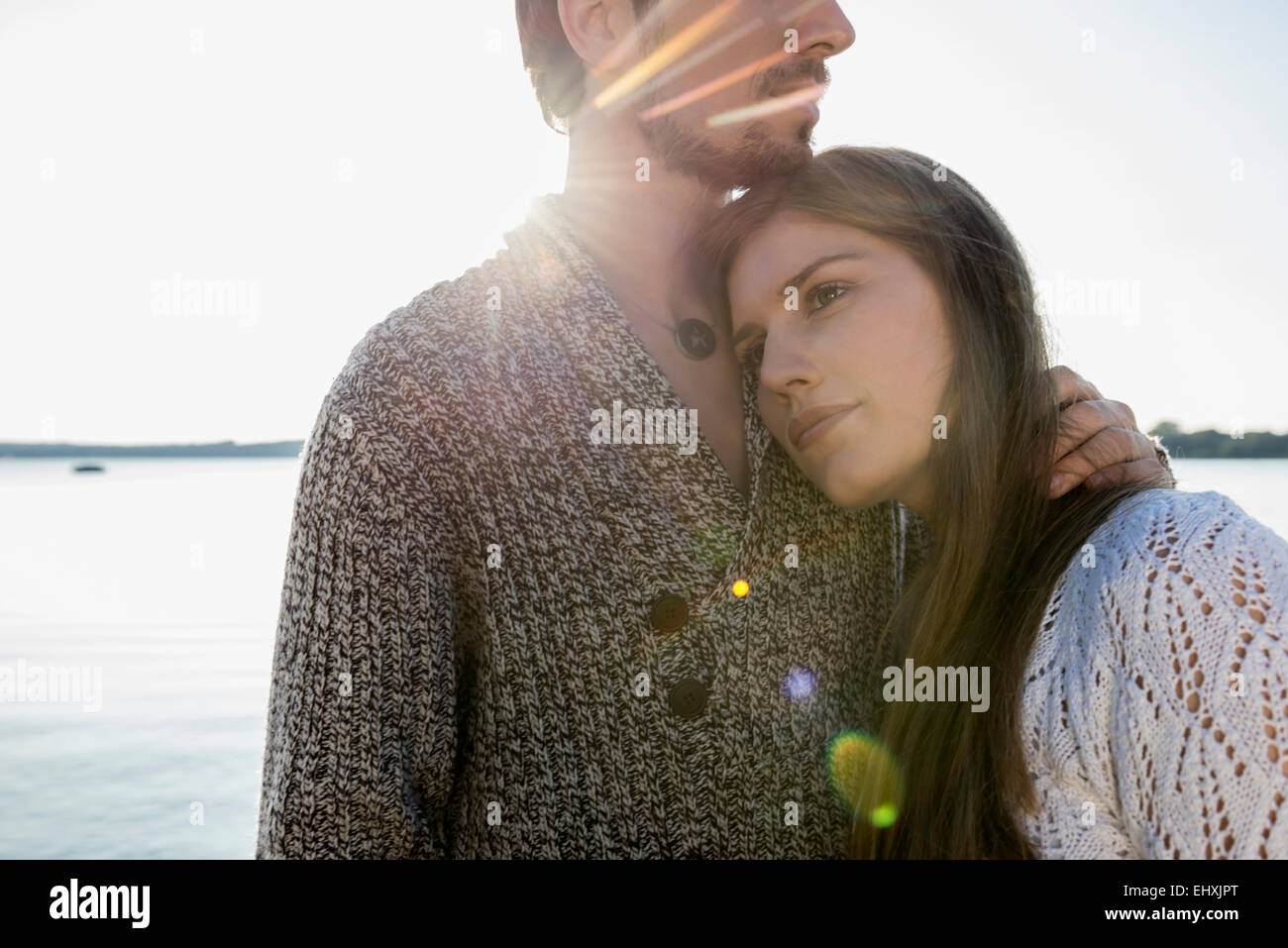 Young couple hugging sunset lake Stock Photo
