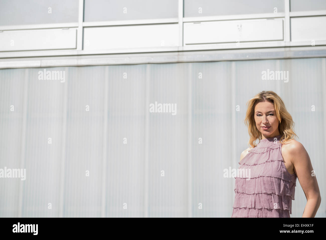 Portrait pretty blond woman wearing lavender dress Stock Photo - Alamy