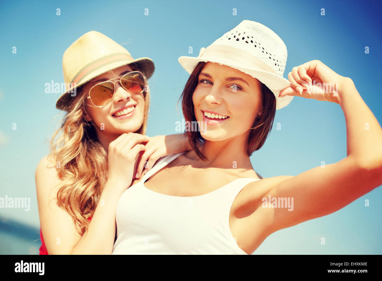 girls in hats on the beach Stock Photo Alamy
