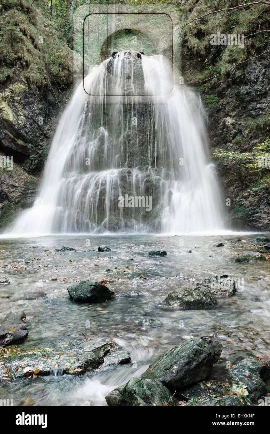 Waterfall falling through power socket, Bavaria, Germany Stock Photo