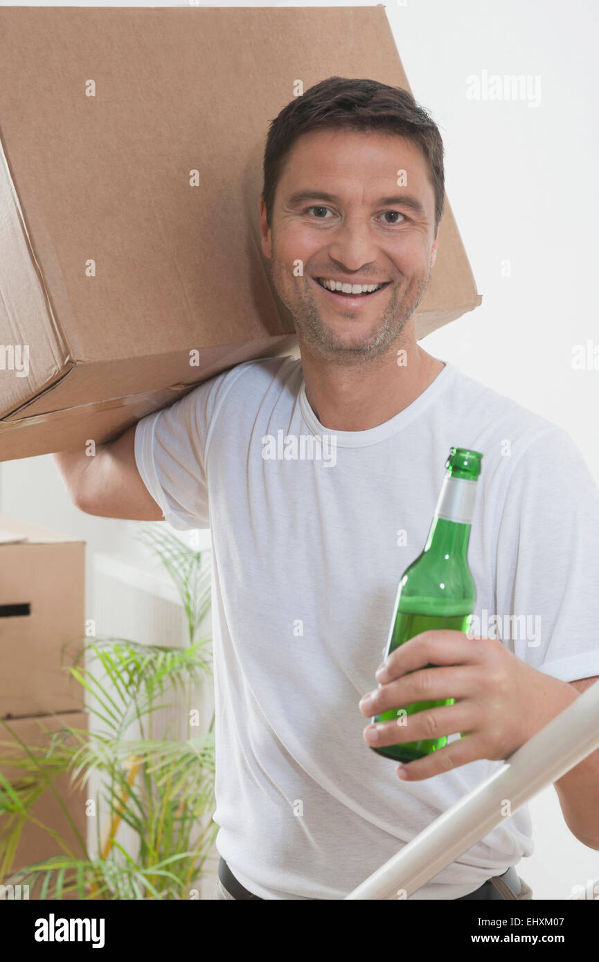 Man drinking beer while moving to his new home, Bavaria, Germany Stock