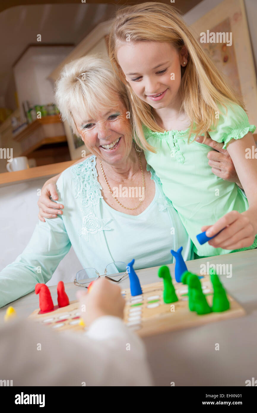 Girl playing board game with her grandmother, Bavaria, Germany Stock Photo