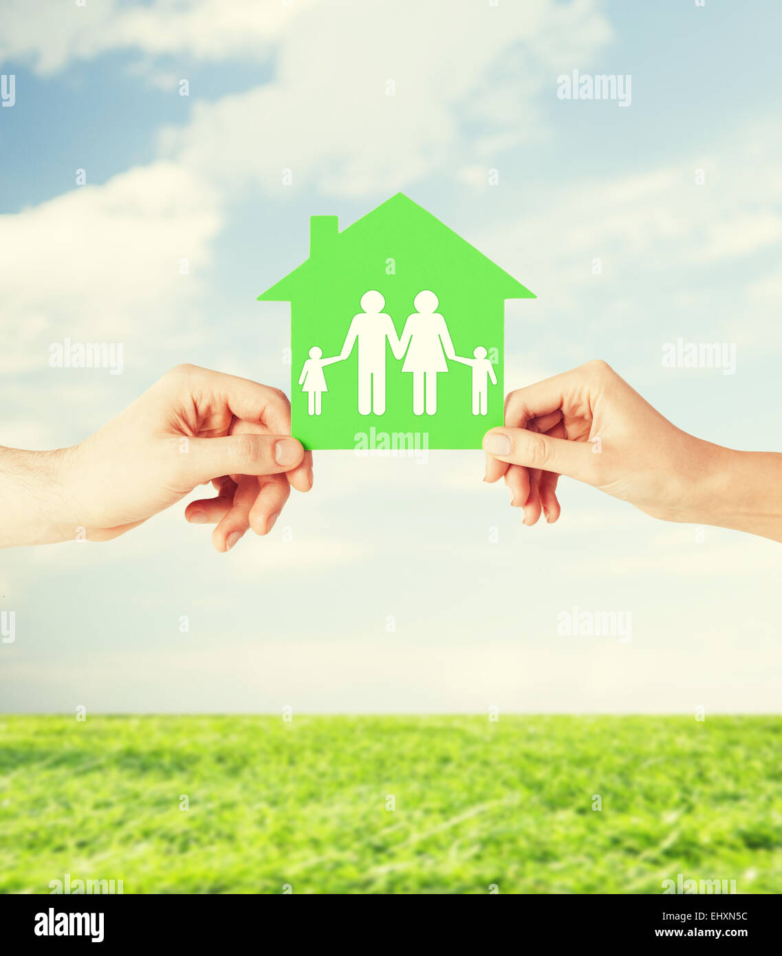 hands holding green house with family Stock Photo - Alamy