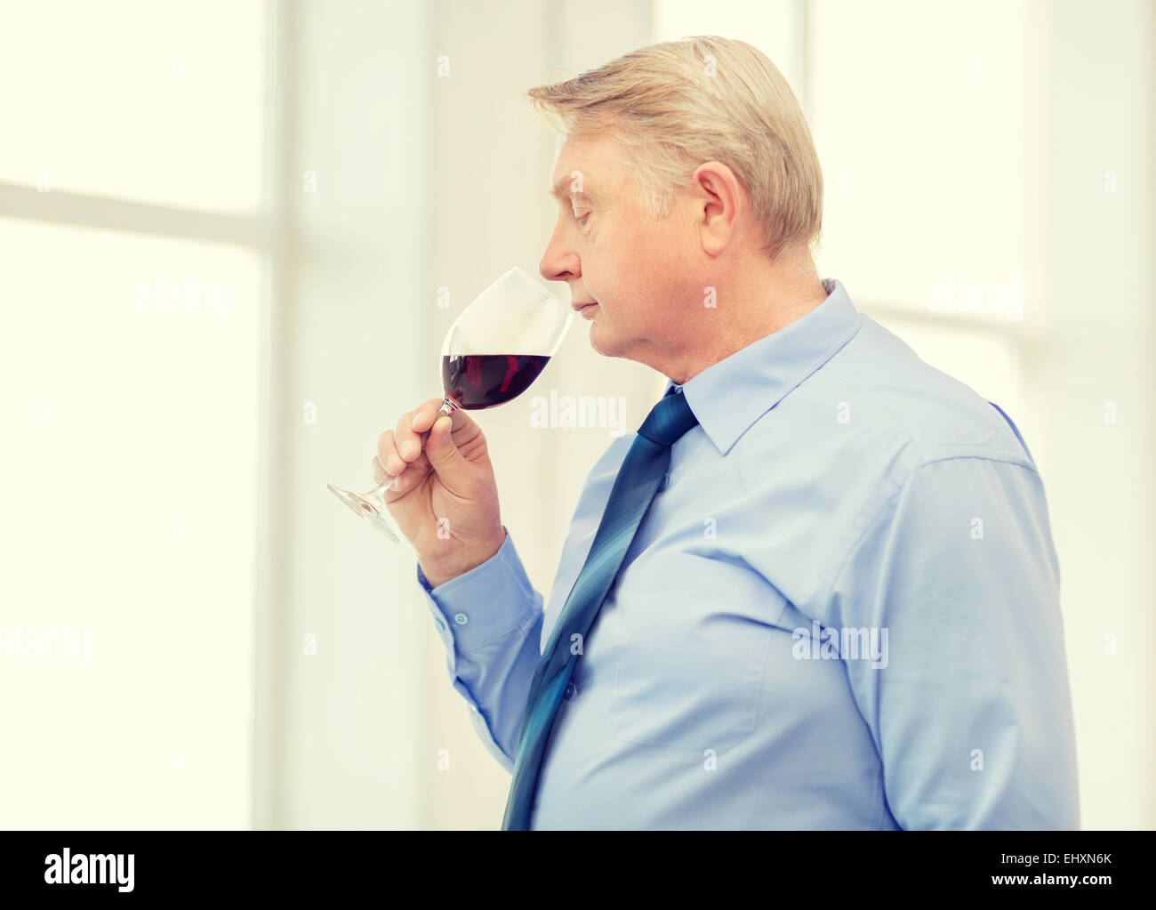 older man smelling red wine Stock Photo - Alamy