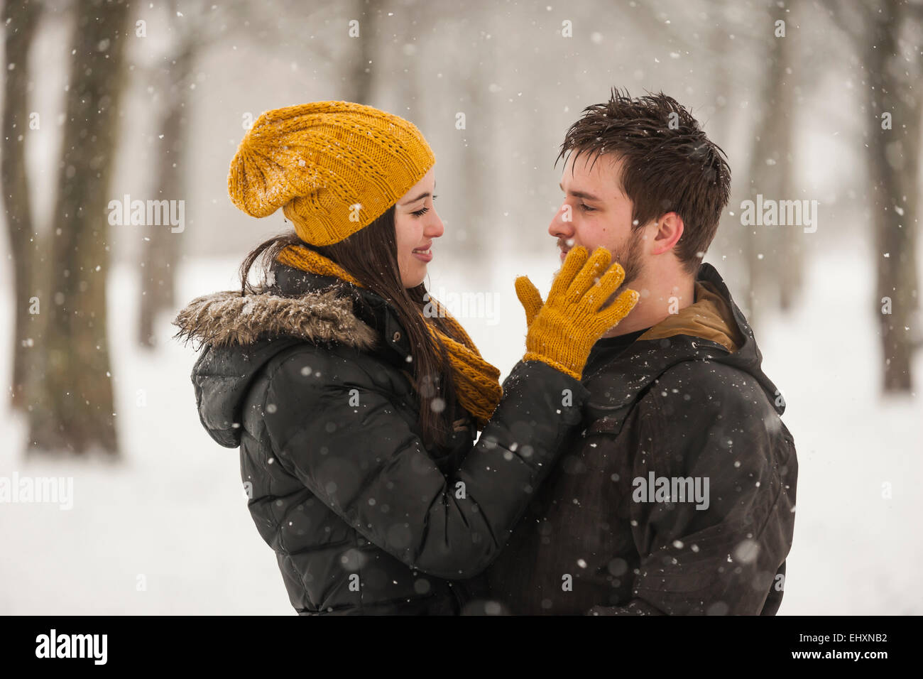 Happy young couple in winter Stock Photo - Alamy