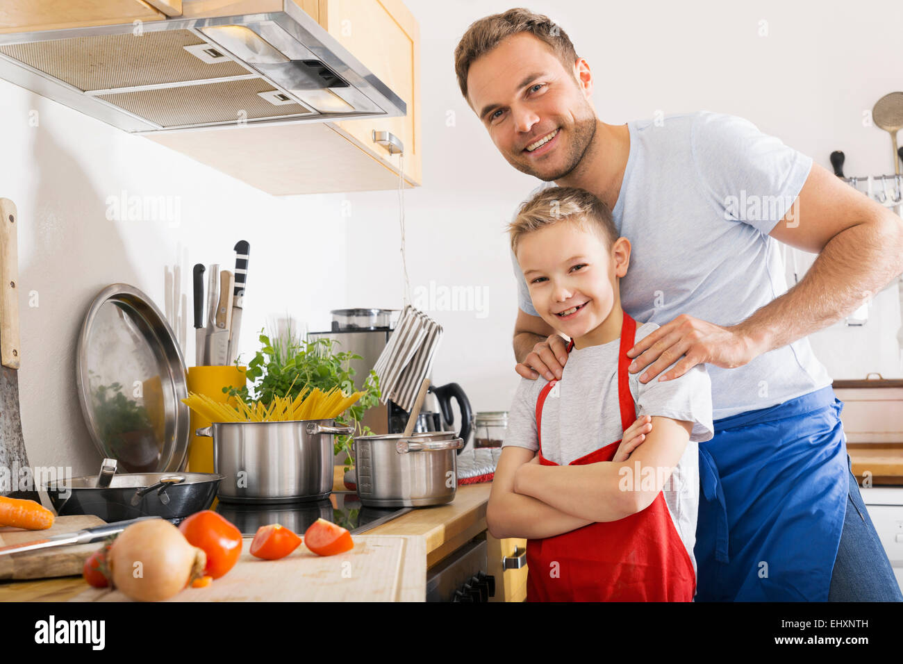 Portrait of father and son in the kitchen Stock Photo - Alamy