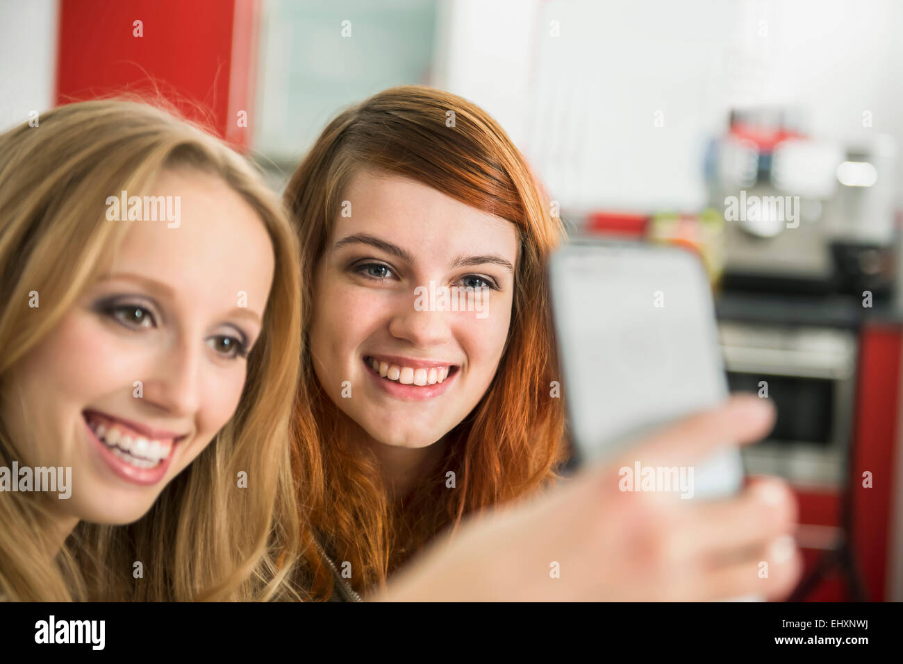 Happy girl friends taking a selfie with smartphone, Munich, Bavaria, Germany Stock Photo