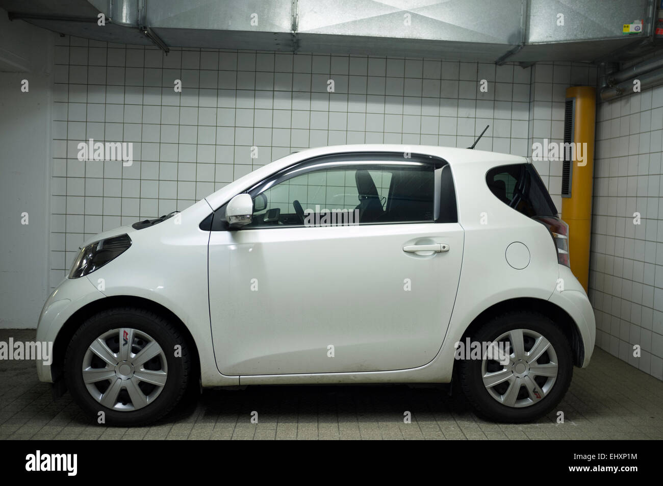 Toyota IQ two-seater car parked in underground car park Stock Photo