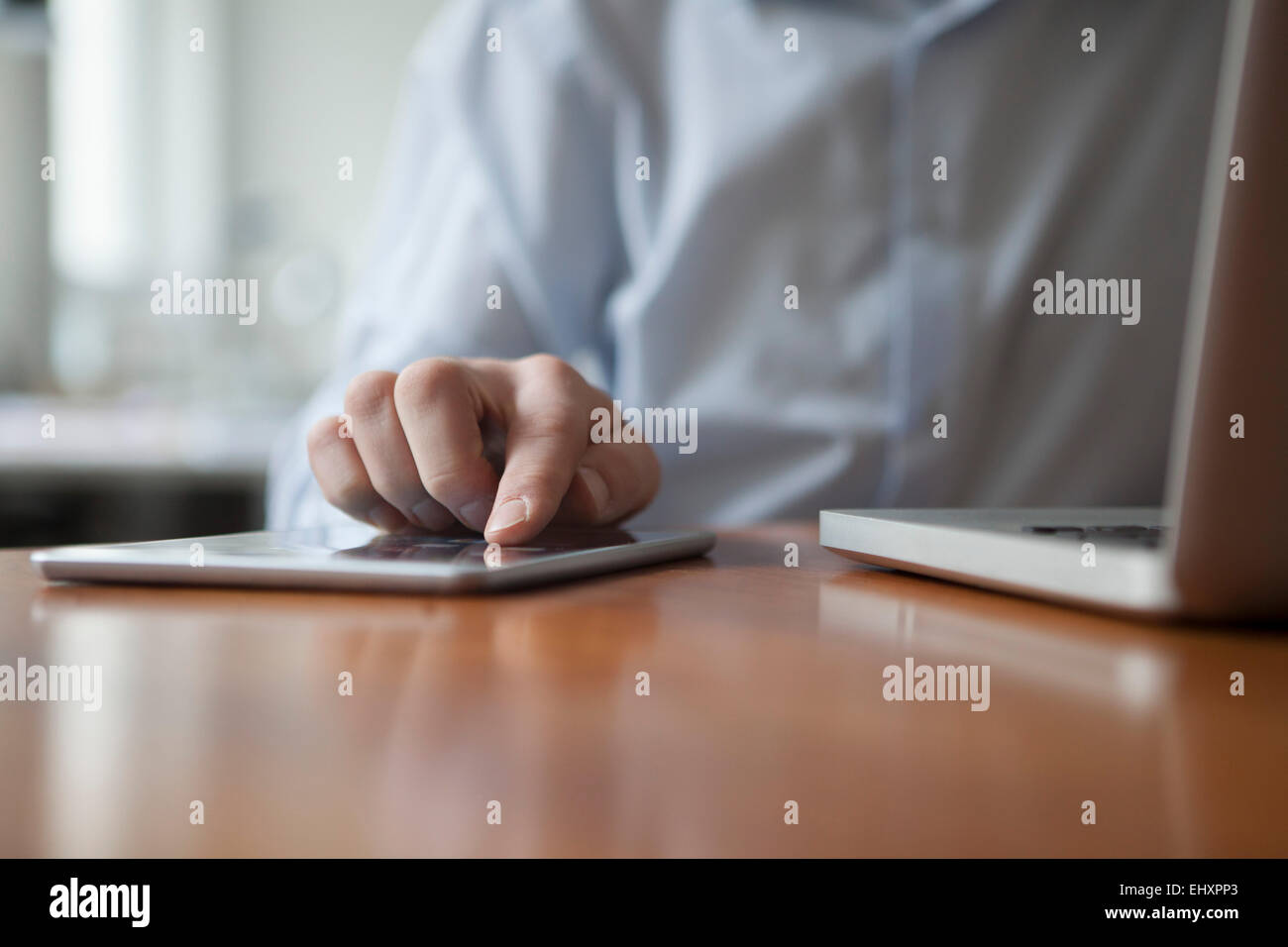 Man's hand typing on touch screen of digital tablet Stock Photo
